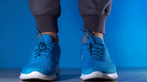 Close up slow motion shot of legs cropped Excited man in sneakers jumping high Stock Footage 106267401