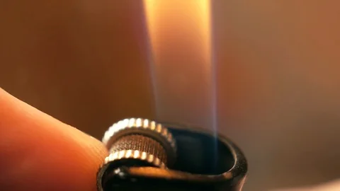 Close up slow motion shot of lighter on the man hand. Macro shot of Igniting lig Stock Footage 120070085