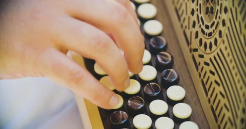 Close up slow motion shot man playing on accordion, musician hands. Stock Footage 117067613