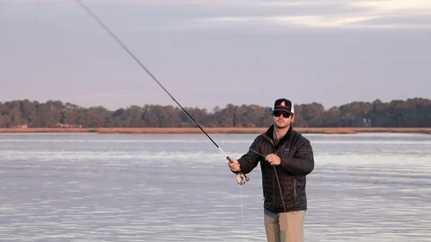 Close up, slow motion shot of man fly fishing facing camera Stock Footage 121275432