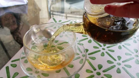 Close-up slow motion shot of a man pouring mint tea Stock Footage 278821225