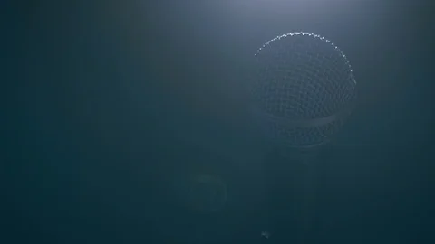 Close up slow motion shot of microphone shining in light Video stock 99069005