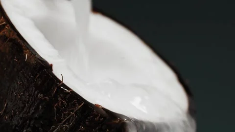 Close up slow Motion Shot of Milk Splashing on Coconut. Stock Footage 141428890