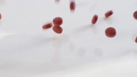 Close up slow motion shot of red prescription pills pouring out onto a table Video stock 153063765