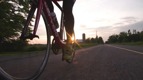 Close-up slow motion shot of road cycling at sunset/sunrise. Vídeo Stock 62959472