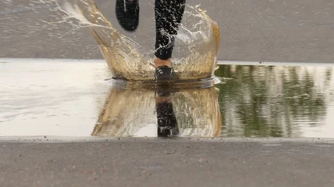 Close up slow motion shot of runner legs step in water Stock Footage 91545541