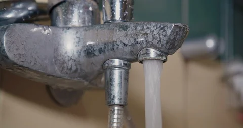 Close up slow motion shot, water flowing under high pressure from the tap. Stock Footage 123607244