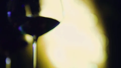 Close up slow motion shot, wine glass with party lights in background. Stock Footage 120839695