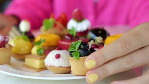 Close-up slow motion shot of a woman's hand with a bright yellow manicure, she Stock Footage 220042964