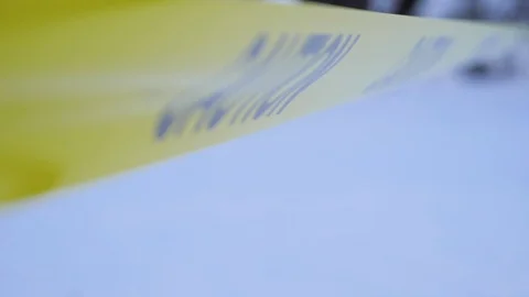 Close up slow motion shot of yellow caution tape blowing in wind	 Stock Footage 122234080