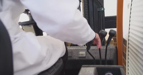 Close up slow motion shot, young man hand drive, operate forklift. Stock Footage 117191936