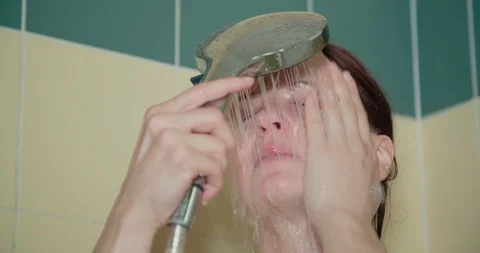 Close up slow motion shot, young caucasian naked woman taking a shower. Stock Footage 123589012
