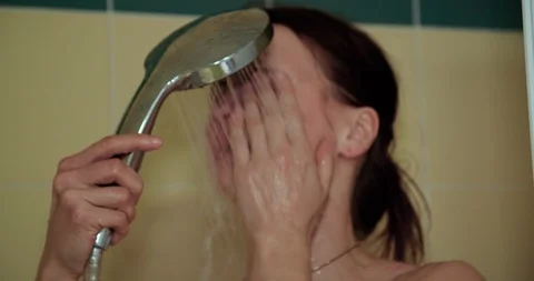 Close up slow motion shot, young caucasian naked woman taking a shower. Stock Footage 123601764