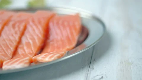 Close-up slow-motion of sliced fresh raw red salmon. Video stock 132786842