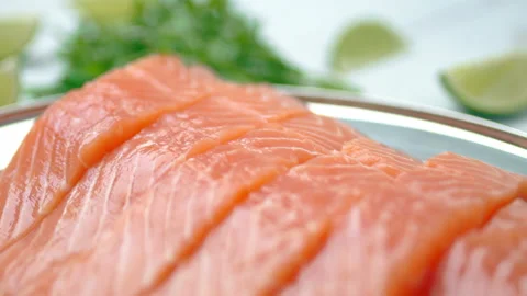 Close-up slow-motion of sliced fresh raw red salmon. Video stock 132787008