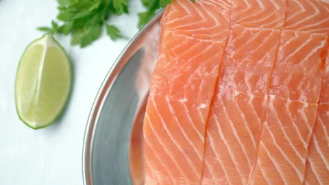 Close-up slow-motion of sliced fresh raw red salmon. Video stock 132787189