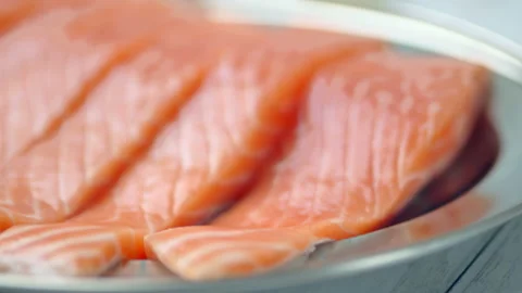 Close-up slow-motion of sliced fresh raw red salmon. Stock Footage 132787512