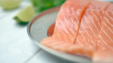 Close-up slow-motion of sliced fresh raw red salmon. Video stock 132787831