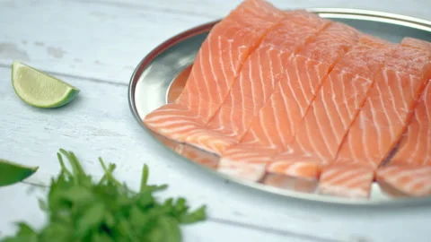 Close-up slow-motion of sliced fresh raw red salmon. Video stock 132787871