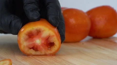 Close up Slow-motion, slicing tomato and showing its juiciness. Stock-Footage 136820432