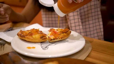 Close up, Slow motion, Squeeze the pizza sauce in the plate slowly. Stock Footage 94660149