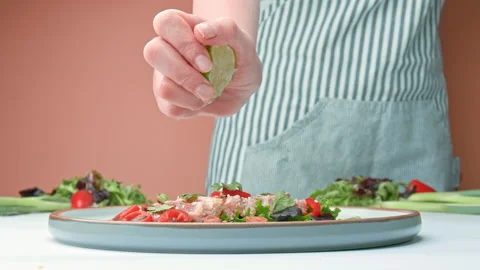 Close-up of slow-motion squeezing half lime on Sesame Crusted Seared Tuna in 4K. Stock Footage 141315474