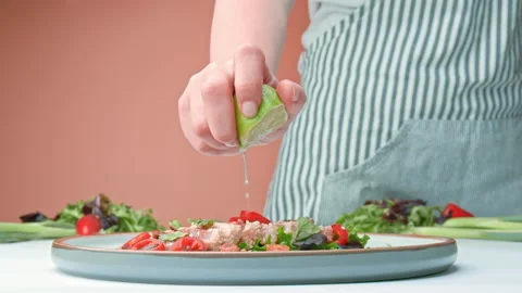 Close-up of slow-motion squeezing half lime on Sesame Crusted Seared Tuna in 4K. Stock Footage 141315519