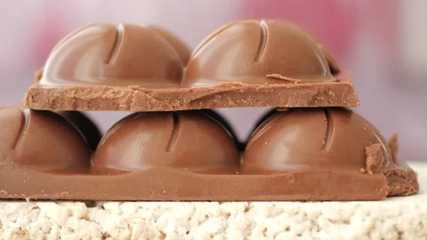 Close up slow motion stack of chocolate bar pieces with rounded shapes. Stock Footage 332627038