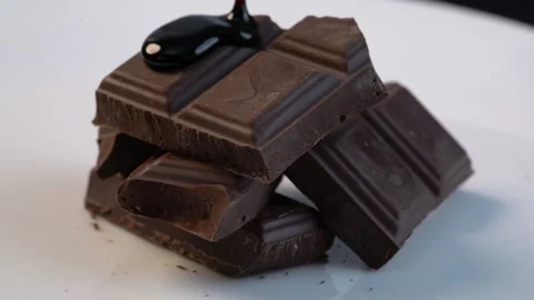 Close up slow - motion stacked chocolate with melted chocolate on top 库存影片 136210219