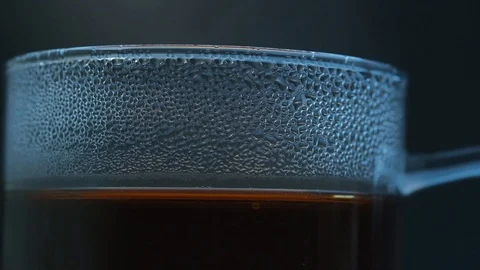 Close up slow motion of steaming coffee tea in a glass mug Stock Footage 121880469