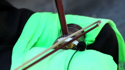 Close-up Slow Motion: Street performer playing Erhu in city - San Francisco, Cal Stock Footage 149714005