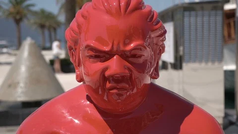 Close up, slow motion. Sumo wrestler statue. Modern art in the park Stock Footage 96128403