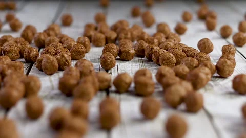 Close up slow motion of throwing chocolate balls on wooden table Stock Footage 140233222