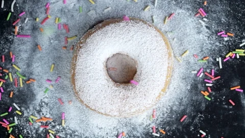 Close up slow motion top angle shot strew colorful chocolate rice with donut Stock-Footage 135859237