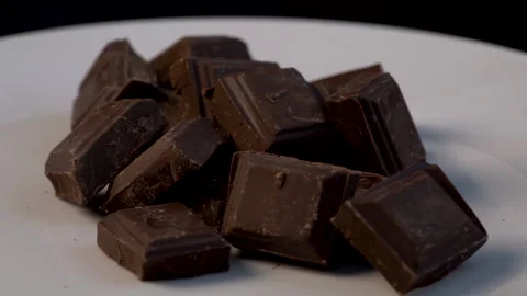 Close up slow - motion turn around many pieces of premium chocolate Видео 136210221