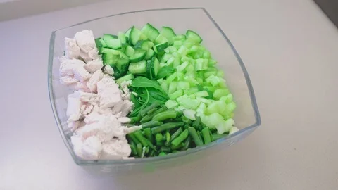 Close-up, slow motion, unrecognized female hand pours vegetable oil on lettuce Stock-Footage 101098312