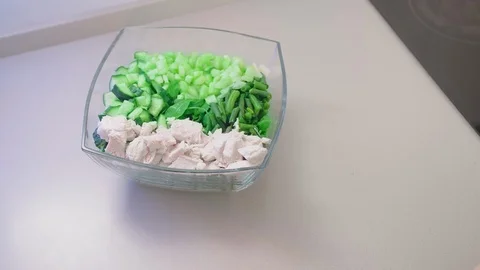 Close-up, slow motion, unrecognized female hand moves glass salad bowl. The Stock Footage 101635068