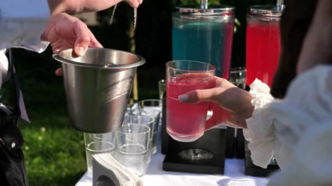 Close-up slow motion video of a bartender tossing ice into a glass for a guest Stock Footage 242849012