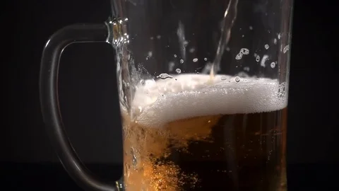 Close-up slow motion video of beer pouring in the mug Stock Footage 82752684