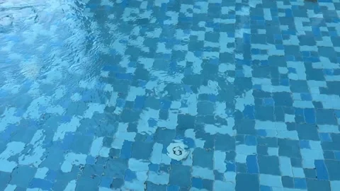 Close-up slow motion video of blue tiled swimming pool water Stock Footage 321182367