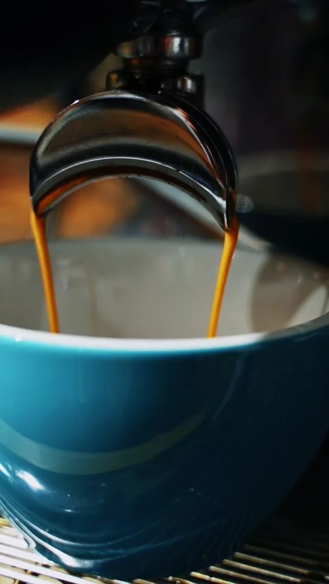 Close up slow motion video of espresso coffee pouring from professional mac.. Stock Footage 337633938