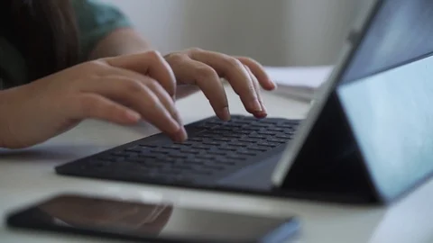 Close up slow motion video of the hands of a woman typing on the keyboard fro Video stock 129637017