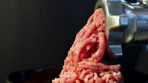 Close-up slow-motion video of lard or meat being processed into minced meat  Stock Footage 257237857