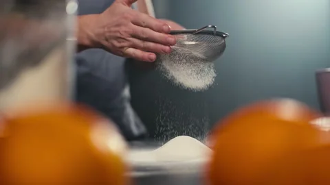 Close-up slow motion video of sifting flour through a sieve. Stock Footage 239234447