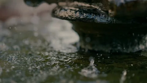Close-up slow motion video of water dripping in the small fountain Video stock 232847704
