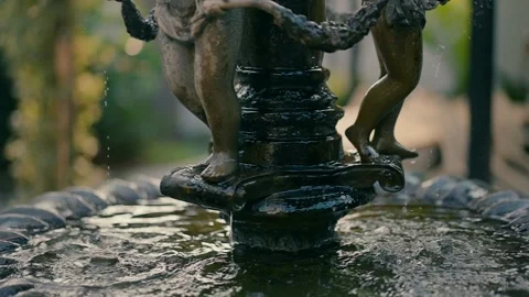 Close-up slow motion video of water dripping in the small fountain Stock Footage 232847798