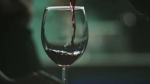 Close-up slow motion video of wine being poured into a glass. Romantic evening Stock Footage 213019121