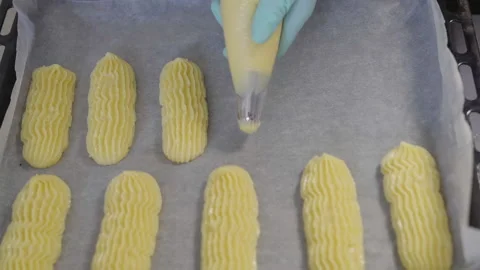Close-up, Slow Motion, View From Above, Pastry in Gloves Squeezes Dough for Stock Footage 136800715