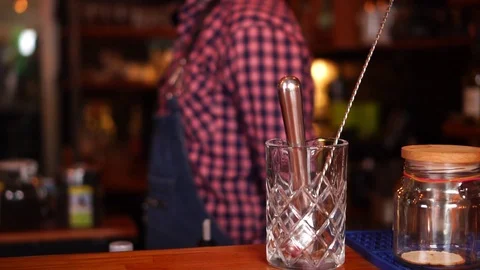 Close up slow motion view on bartending instruments next to glass jars with Stock Footage 104373960