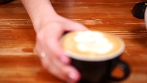 Close up slow motion view on beautiful flower coffee latte art made with hot Stock Footage 105453977